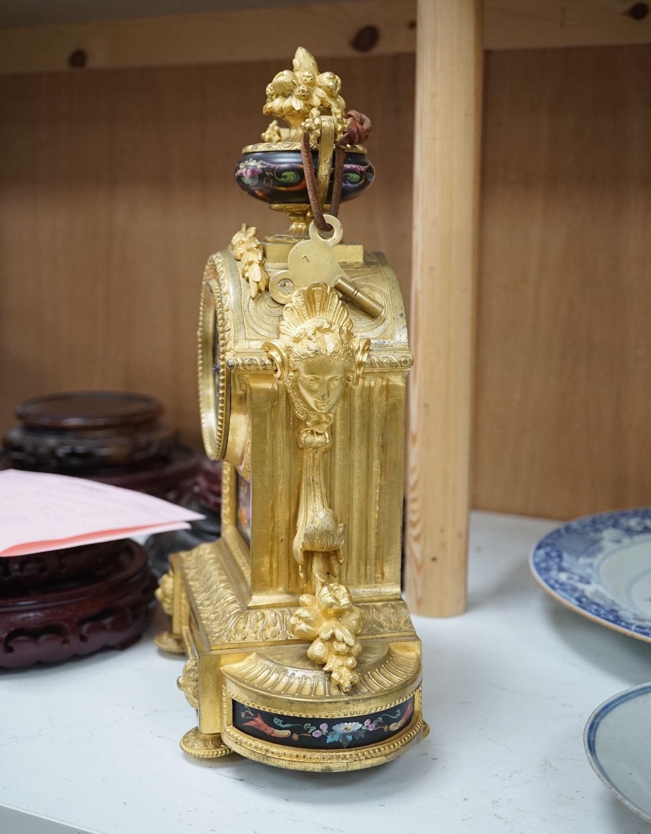 A French ormolu, black figural porcelain mounted mantel clock, 28cm wide x 36cm high. Condition - face and ormolu worn, unknown if clock working.